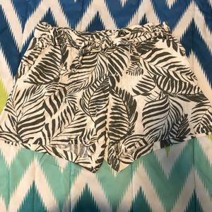 Green and white tropical shorts.